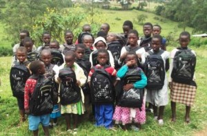 chem_children_after_receiving_books_bags_,pens_and_pencils_from_Egessa_Dorothy